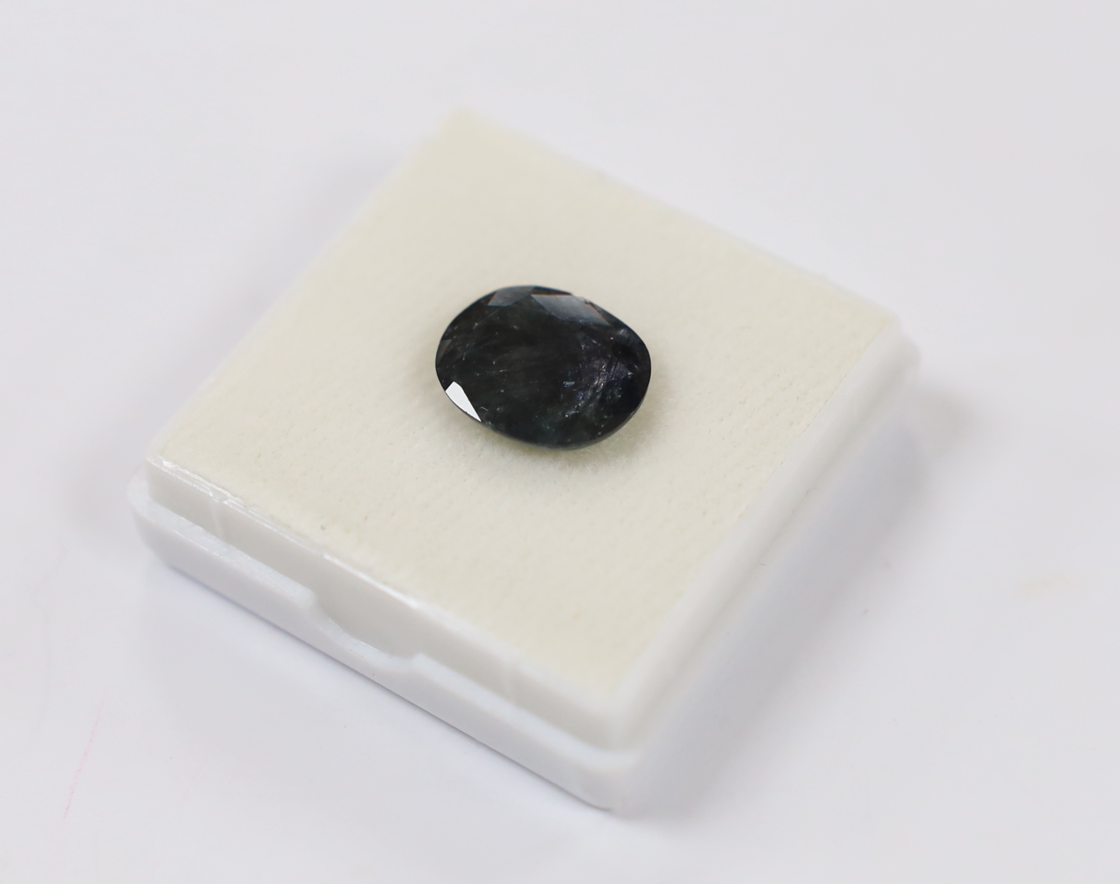 An unmounted cushion cut sapphire, weighing 8.67ct.